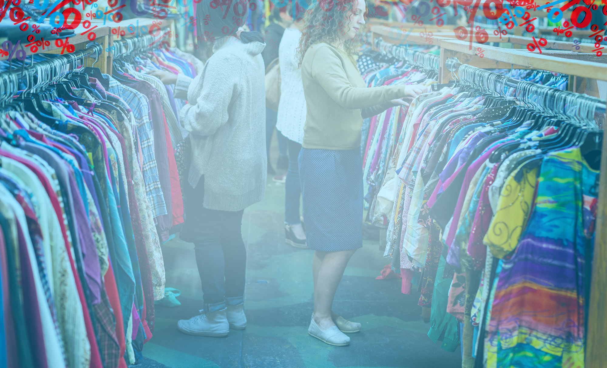 Women browsing through vintage clothing in a Thrift Store. Racks of clothing at Bargain Thrift Store