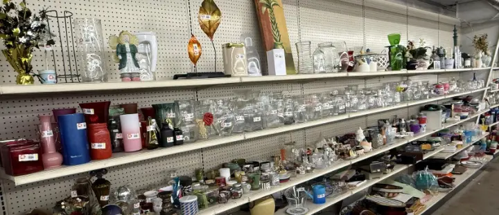 Vases, candles and home decor on shelves at Bargain Thrift Store