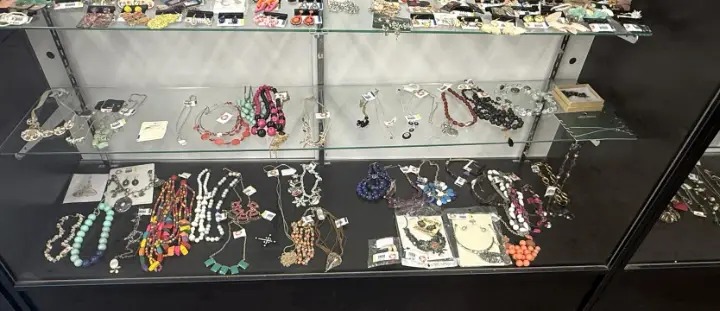 Necklaces and jewelry in a glass showcase at Bargain Thrift Store