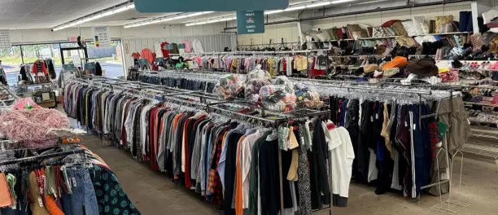 Men’s clothing racks under the Ropa de Hombre sign at Bargain Thrift Store